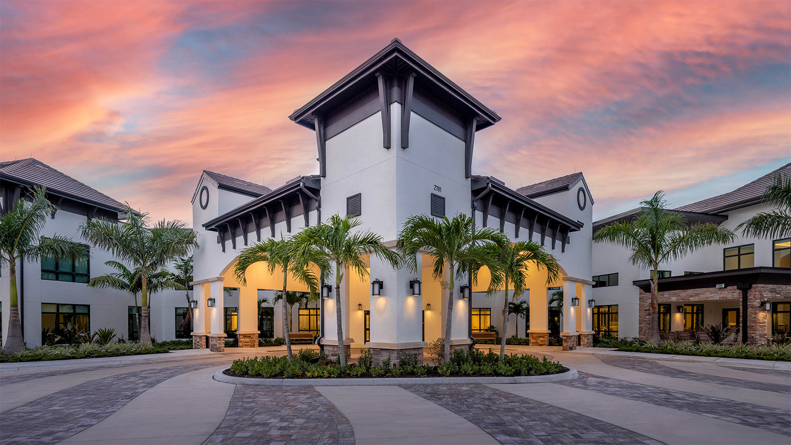Exterior shot of Siena Lakes community building during sunrise.