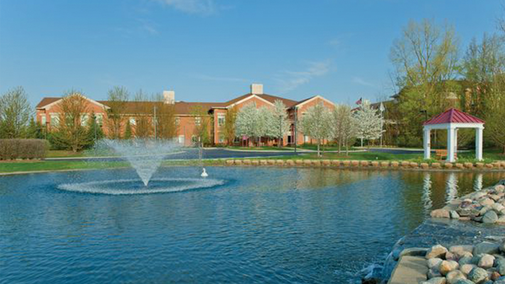 Fountain in pond outside of community building.